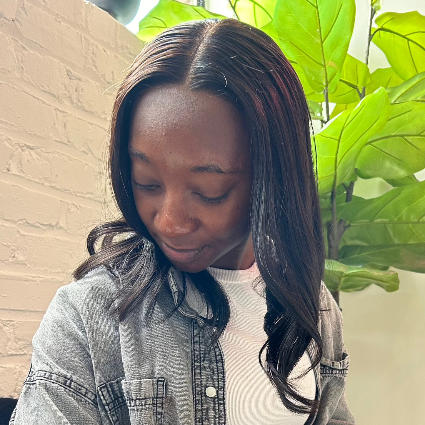 Black woman wearing a glueless middle part HD closure unit with a natural hairline