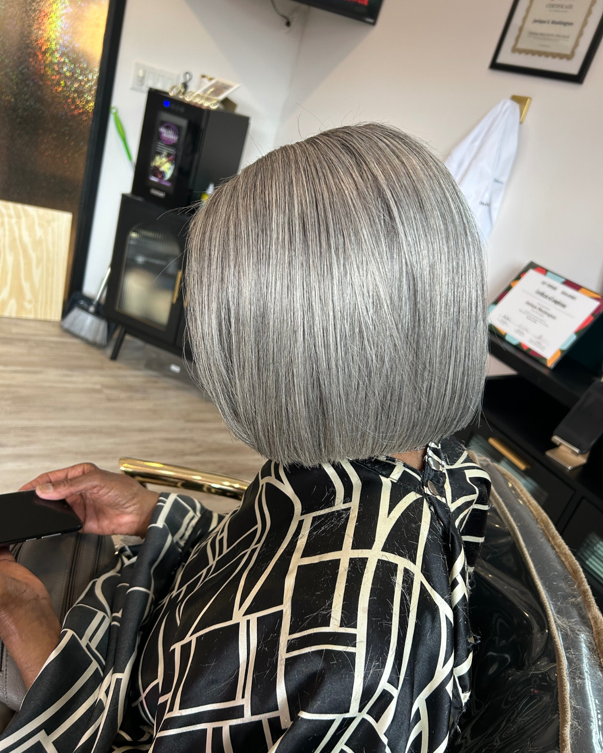 Person with a stylish cranial prosthesis silver bob haircut at The Chic Studio