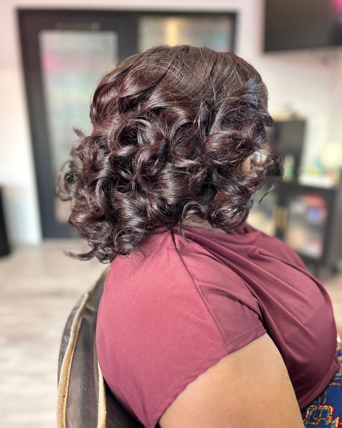 Black woman with deep burgundy colored cranial prosthesis 