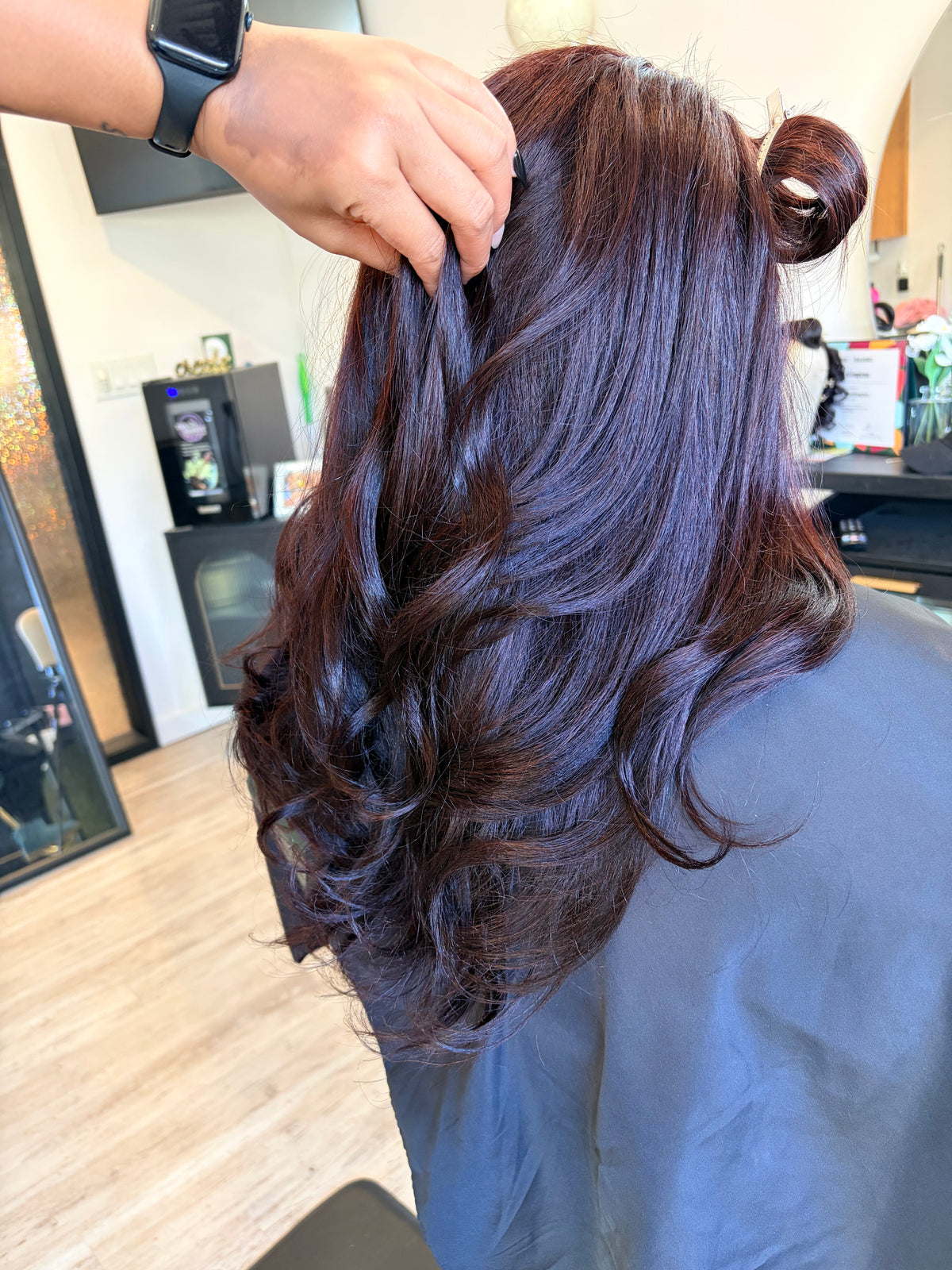 Full cranial prosthesis colored to a deep burgundy with light curl at The Chic Studio