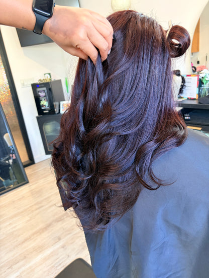 Full cranial prosthesis colored to a deep burgundy with light curl at The Chic Studio