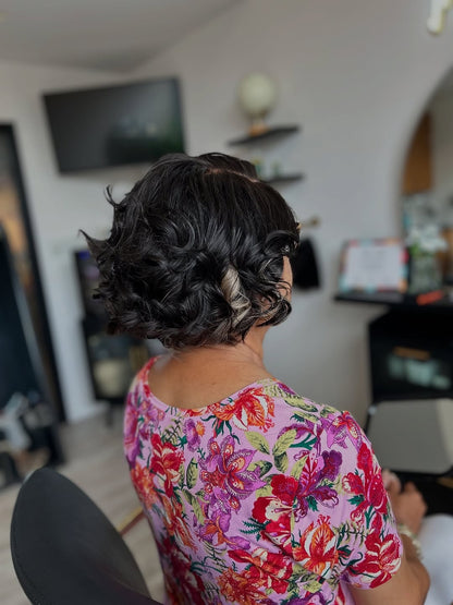 Older woman wearing a bob cranial prosthesis that has been curled and has hints of grey at The Chic Studio