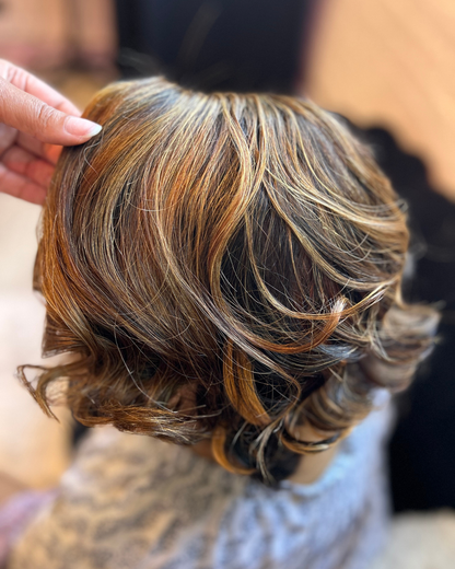 Veteran wearing a full cranial prosthesis with HD lace, cut into a bob, and curled at The Chic Studio