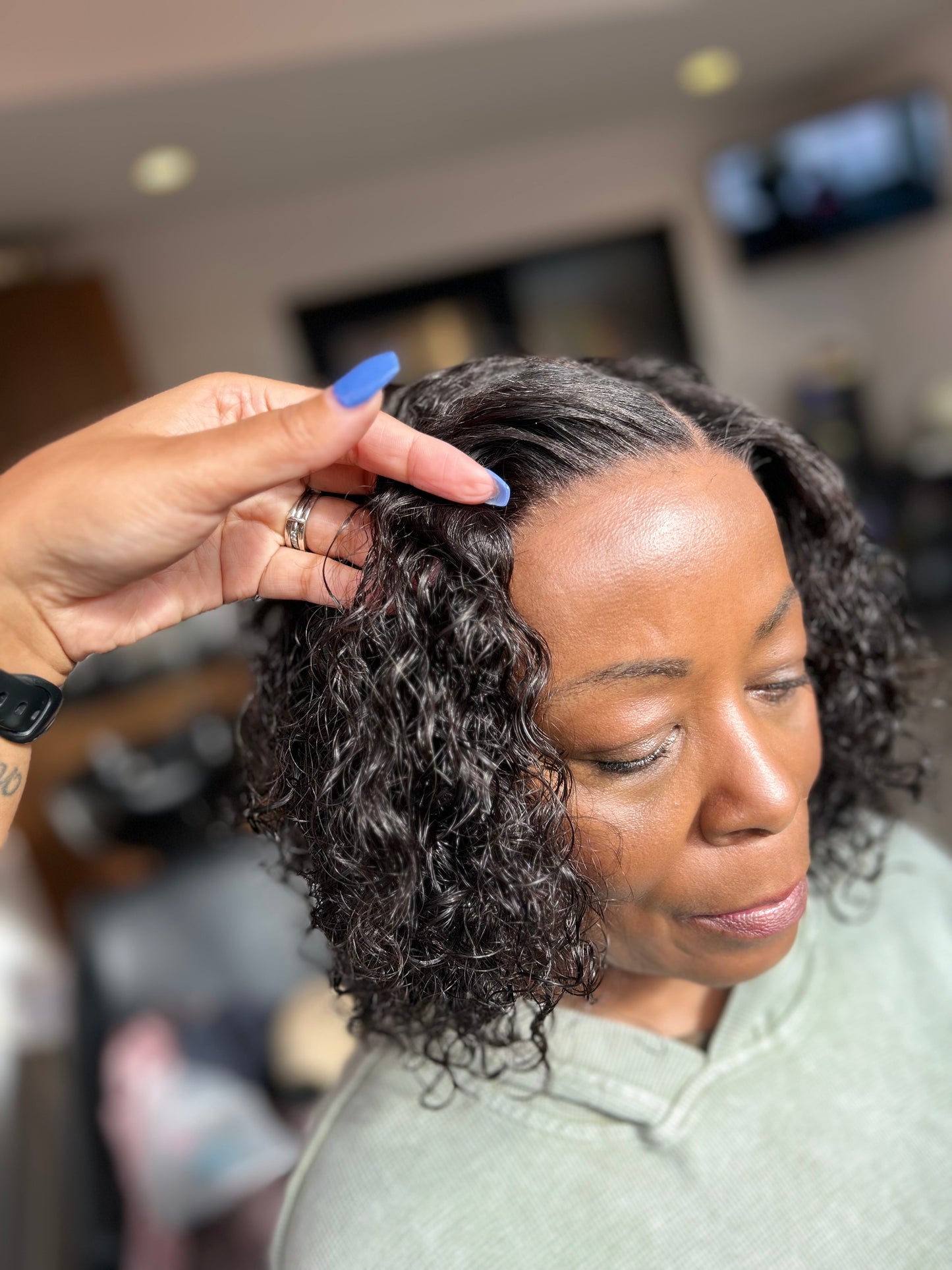 Veteran wearing curly bob cranial prosthesis at The Chic Studio