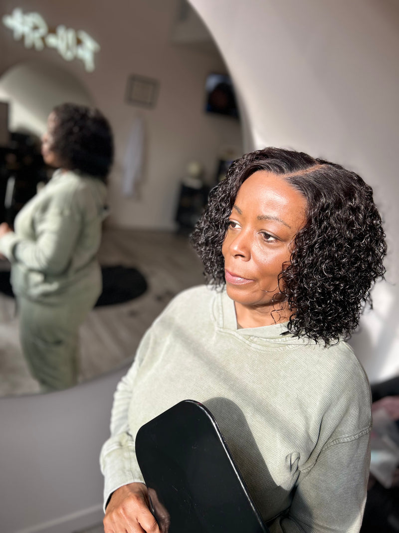 Veteran wearing curly bob cranial prosthesis with HD Lace at The Chic Studio